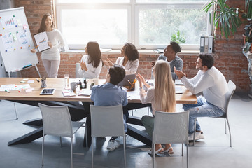 Young girl sharing new business ideas with colleagues