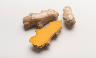 Yellow fresh Turmeric root or Curcuma longa on white