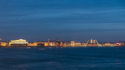 Fototapeta na wymiar Night view of spit of Vasilyevsky Island and opened Birzhevoy Bridge with rostral column timelapse, Saint Petersburg, Russia.
