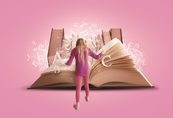 Schoolgirl Reading - Studying Big Open Book with Letters and Books on Pink Background