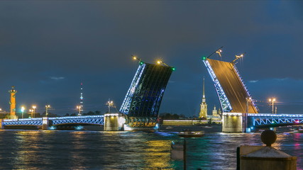 Fototapeta na wymiar View of the open Palace Bridge timelapse, which spans between - the spire of Peter and Paul Fortress