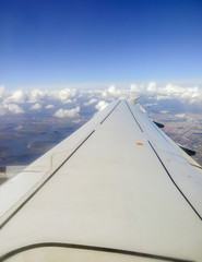Fototapeta na wymiar wing of an airplane in blue sky