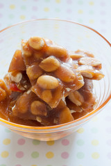 Peanut brittle pieces of hard sugar candy with peanuts