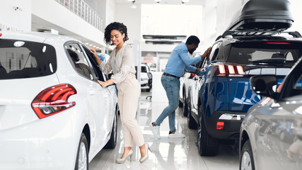 African Spouses Choosing Family Automobile In Luxury Dealership Store, Panorama