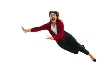 A second before falling. Caucasian young girl falling down in moment with bright emotions and...