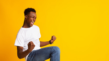 Portrait of handsome african guy showing breakthrough gesture