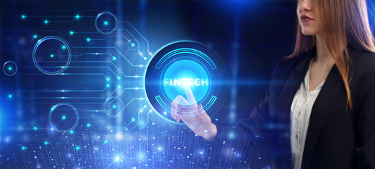 Business, Technology, Internet and network concept. Young businessman working on a virtual screen of the future and sees the inscription: Fintech