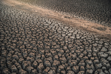 Global warming concept. drought cracked desert landscape. Soil drought cracked landscape sunset. Texture of dry cracked earth. The desert background. The global shortage of water on the planet.