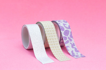 decorative tape for scrapbooking. Design albums, notebooks, diaries. Adhesive tape with glitter, gold, silver. on a pink background