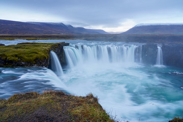 Godafoss waterfall. Beautiful landscape in Iceland. Cloudy sky with waterfall and smooth water flow