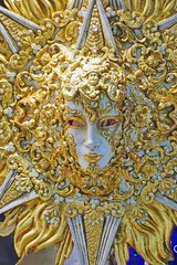 Golden Venetian carnival mask on the street in Venice