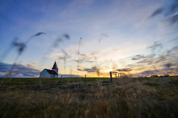 Woolden Church of Hellnar with grass field and sunset view at Snaefellsness, Vesturland, Iceland