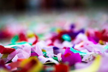 Artistic image of confetti of all colors, pink, blue, yellow, purple, vibrant color gradient, photographic effect and close up and horizontal image in Los Angeles California