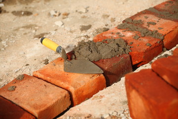 Red brick in the earthen canal during construction tropical.