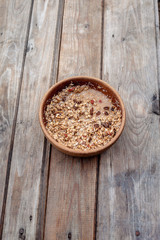 Oatmeal on the table. oatmeal in brown bowl on old wooden table.