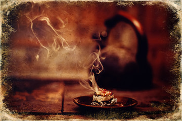 Frankincense burning on a hot coal. Aromatic frankincense. Old photo effect.