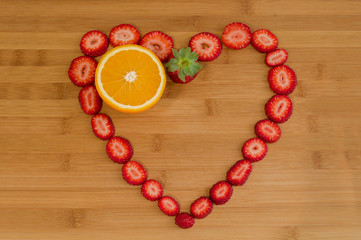heart shaped strawberries on wood and two orange