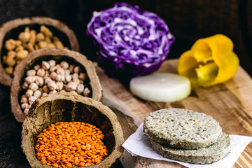 vegan hamburger based on various vegetables, raw, without frying, on wooden background.Vegan food and healthy living concept.