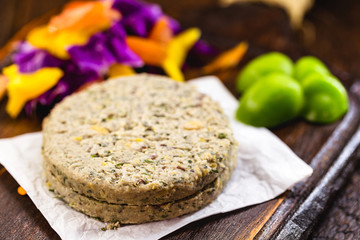 vegan hamburger based on various vegetables and various types of soy or chickpeas, without frying, on a rustic wooden background.Concept of healthy vegetarian meal and vegan food.