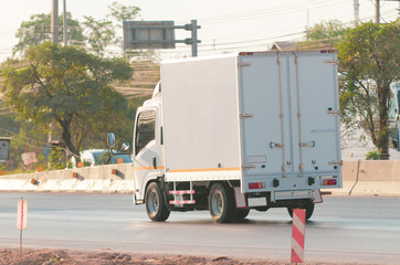 Samut Sakhon, Thailand - January 2020: Small white trucks running on Rama 2 Road on January 2, 2020 at Samut Sakhon Province, Thailand.