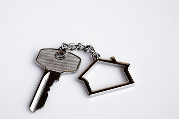 House key ring with antique key on white background. Property investment. Home finance concept.