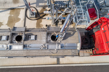 pouring chemical components into a tanker at the factory