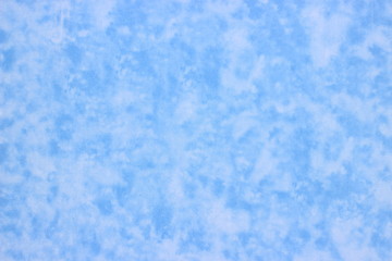 A sheet of plastic decorated with abstract, blue-white indistinct spots that look like small clouds