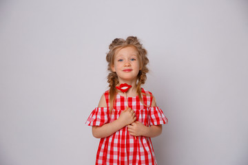 Funny smiling baby girl summer dress  on white background . Baby girl with a lip accessory on a stick.