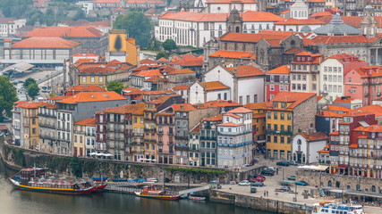 Beautiful view of the Douro River timelapse and the embankment of the historic centre of Porto city on the blue sky background in Portugal at summer time.