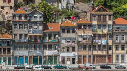 traditional quaint houses in the old, vintage and touristic ribeira district of Porto at sunny day timelapse, Portugal