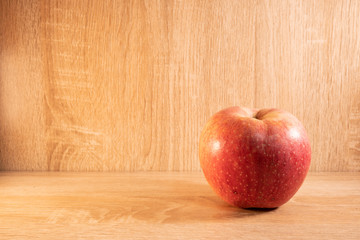 Apple on wooden table .