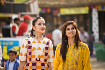 Two happy Indian women at street market