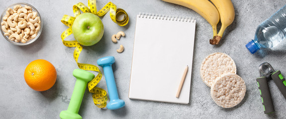 Fitness and healthy eating concept with blank notepad