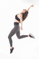 a jumping sportswoman over white background