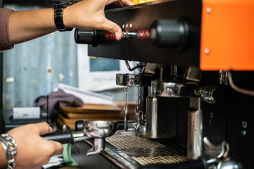 Man hand make coffee by espresso machine hot pouring