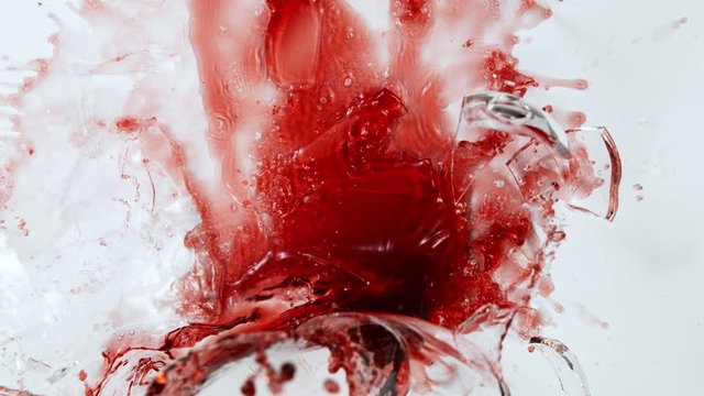 Super Slow Motion Top Shot of Breaking Glass with Red Wine on White Cloth at 1000fps.