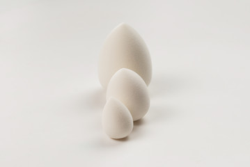Small, medium and large  white beauty blender isolated.