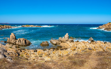 Fototapeta na wymiar Panoramic view of Capo Figari cape rocks and seashore of Spiaggia di Cala Spada beach at the Tyrrhenian Sea coast in Golfo Aranci, Sardinia, Italy