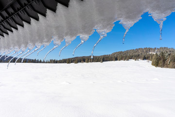 Icicles on the roof . Around Oravice. Tatry. Slovakia.