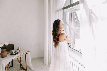 Portrait of a young beautiful woman. Bride in elegant classic wedding dress. Morning of the bride....
