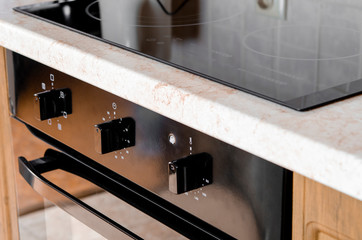Kitchen concept. The cooking surface and oven are built into kitchen furniture