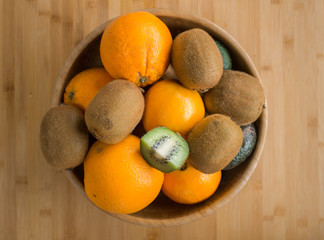 Bowl with kiwi oranges and avocados