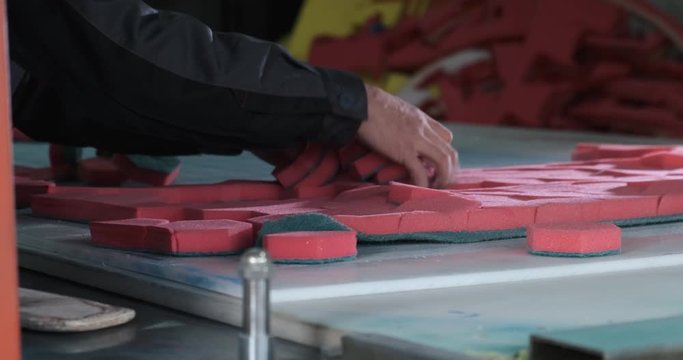 Plant for production of paralon products, stamping of sponges for washing tiles and dishes, hexagonal shape, paralon products, man pull red sponges from cut sheet of synthetic material, low paying job