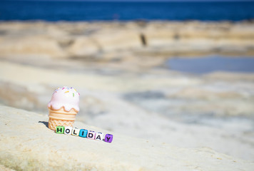 Fototapeta na wymiar Happy holiday sign on the beach sand. summer vacation background