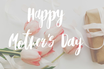 Happy mother's day.  Happy mother's day text and pink tulips with gift box on white background....