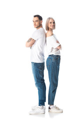 young tattooed couple standing back to back isolated on white