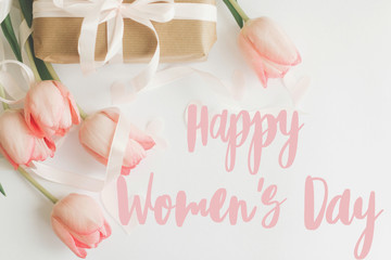 Happy womens day.  Happy women's day text on pink tulips with gift box on white background. Stylish...