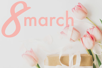 8 march. Happy womens day greeting card. 8 march text on pink tulips and gift box with ribbon on white background. Stylish tender image. Handwritten text, lettering