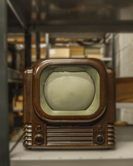 An old black and white television of the 1950s part of media heritage put away on a shelf in...