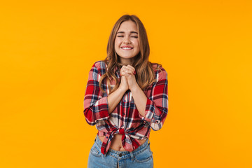 Image of happy young attractive woman praying or making wish